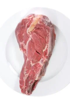 Fresh raw red ribeye beef steak on big white plate Stock Photos