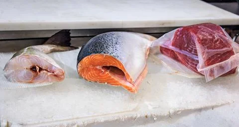 Fresh raw salmon, cod fish tail and tuna fillet at a food market, Sanremo, .. Stock Photos