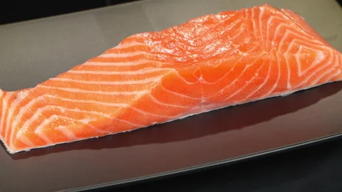 Fresh Raw Salmon Fillet Rotating on Plate Stock Footage 342620209