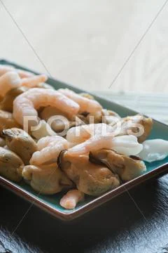 Fresh raw seafood mix of prawns mussels and squid on serving platter Stock Photos