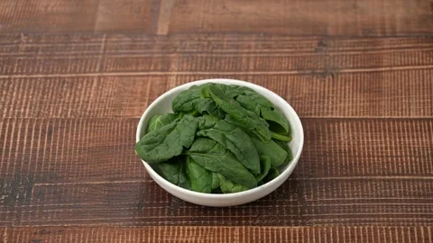 Fresh raw spinach on plate Stock Footage 183507500