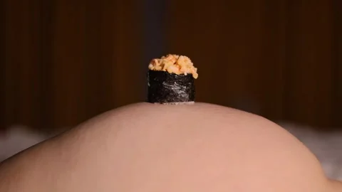 Fresh raw sushi, fish roll on human table, female body Stock Footage 326825751