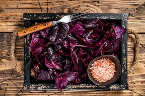 Fresh raw Swiss Ruby or red chard salad Leafs in a wooden tray. wooden Stock Photos