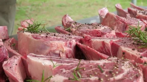 Fresh Raw T-Bone and Ribeye Steaks Seasoned with Pepper and Rosemary Prepared fo Stock Footage 338212981