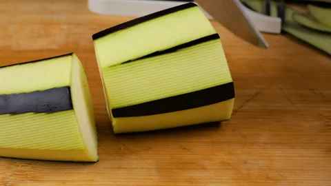The fresh raw vegetable is carefully sliced for cooking. Stock Footage 341536770