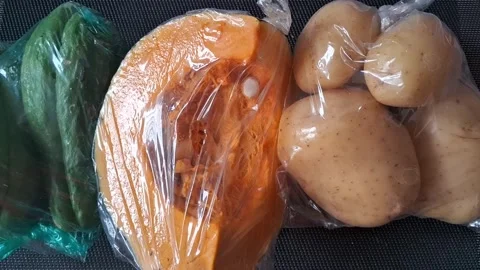 Fresh raw vegetables packed inside clear plastic bags motion footage Stock Footage 339374503