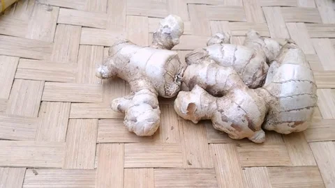 Fresh Raw Whole Ginger Roots on Bamboo Mat Stock Footage 340538299