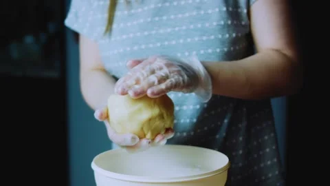 Fresh recipe sequence of rolling cookie dough between gloved hands Stock Footage 342154882