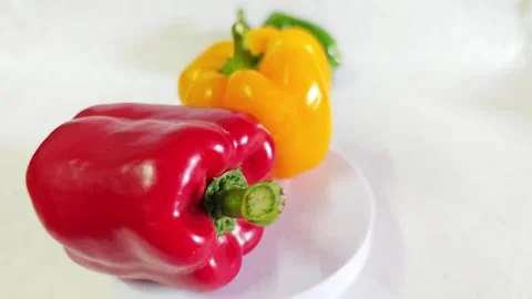 Fresh red and yellow bell peppers on white background. Video stock 340938196