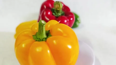 Fresh red and yellow bell peppers on white background. Stock Footage 340938246