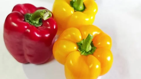 Fresh red and yellow bell peppers on white background. 스톡 동영상 340938273