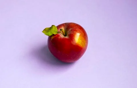 Fresh red Apple on purple background, Top view Stock Photos