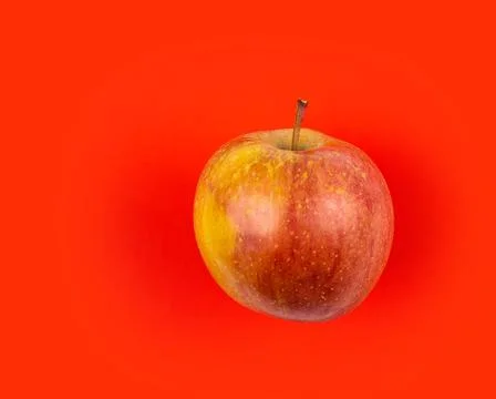 Fresh red apple on red background. Stock Photos
