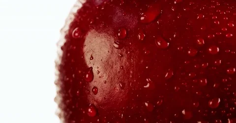 Fresh Red Apple skin close up with water droplet flowing down 4K video Stock Footage 83465240