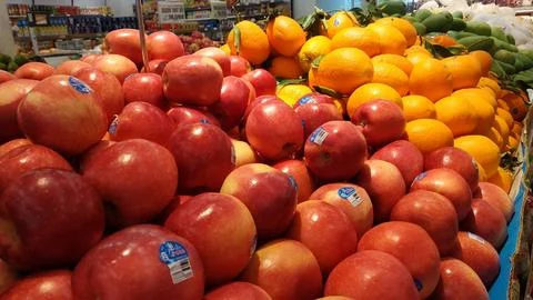 Fresh Red Apples and Juicy Oranges on Display in a Grocery Store Stock Photos