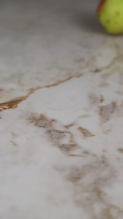 Fresh red apples rolling on a marble countertop Stock Footage 346538555