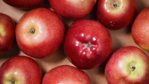 Fresh red apples on rotating background. Top view. Vegan and raw food concept. Stock Footage 125354116