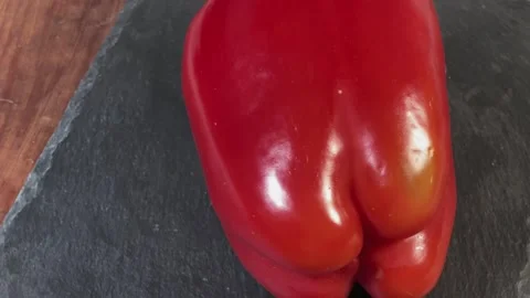 Fresh red bell pepper on a black slate flat plate 動画素材 337653968