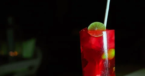 Fresh Red Berry Cocktail with Lime Slice in Night Resort Bar Stock Footage 344916771