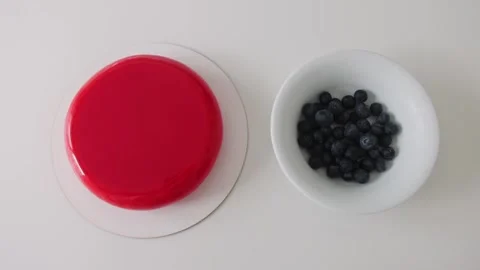 Fresh red cake and blueberries on plates Stock Footage 308225908