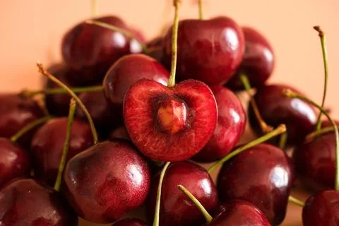 Fresh red cherries with one cut open Stock Photos