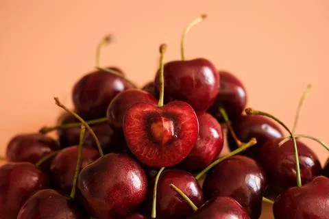 Fresh red cherries with one cut open Stock Photos