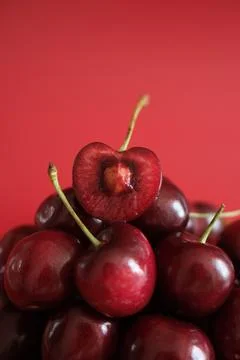 Fresh red cherries on red background Stock Photos