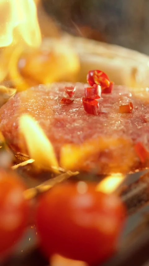 Fresh red chili pieces falling onto raw ground beef burger patty grilling o.. Stock Footage 337537542