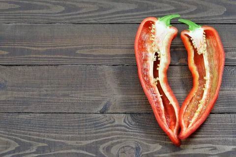 Fresh red chilli pepper cut in half on wooden background with copy space Foto stock