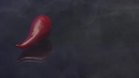 Fresh red chilly pepper with smoke isolated on a black background. Stock footage Stock Footage 143985990