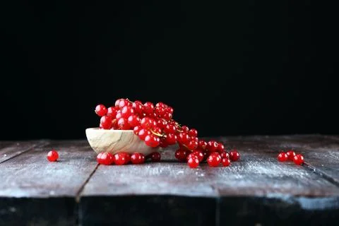 Fresh red currants on light rustic table. Healthy summer fruits. Stock Photos