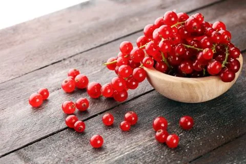 Fresh red currants on light rustic table. Healthy summer fruits. Stock Photos