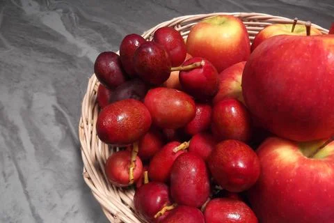 Fresh red dates and apples ready to eat Stock Photos