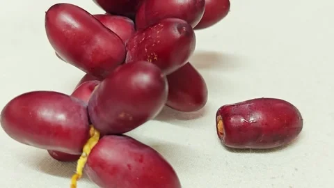Fresh Red Dates Cluster with Single Fruit on Cream Background. Stock Footage 340488256