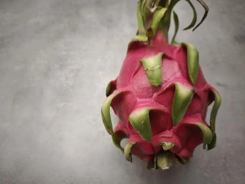 Fresh red dragon fruit lying on gray background Stock Photos