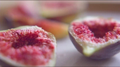 Fresh red fig cut in quarter slice on table Stock Footage 76136062
