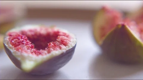 Fresh red fig cut in quarter slice on table Stock Footage 76198112