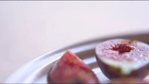Fresh red figs cut in quarter slice in plate Stock Footage 76136477
