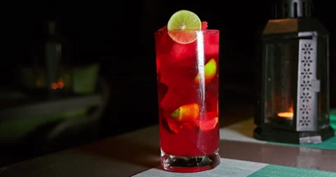 Fresh Red Fruit Cocktail with Lime on Evening Restaurant Table Stock Footage 344813039