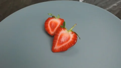 Fresh red half strawberries rotating Stock Footage 107731731