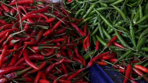 Fresh red hot chilli peppers at local market. Stock Footage 307286675