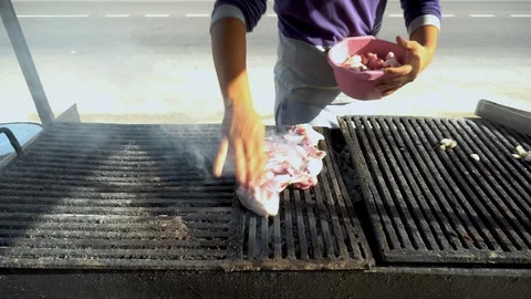 Fresh red meat is grilled over charcoal. A man puts raw meat on a grill. Smoke Stock Footage 120598206