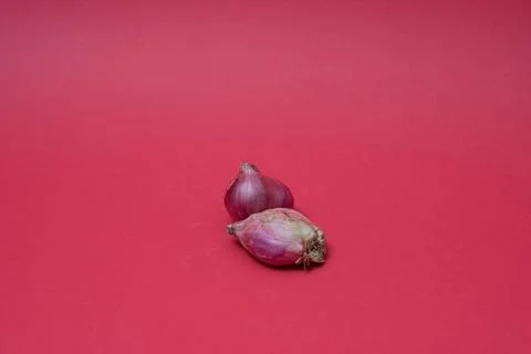 Fresh red onion on red background Stock Photos