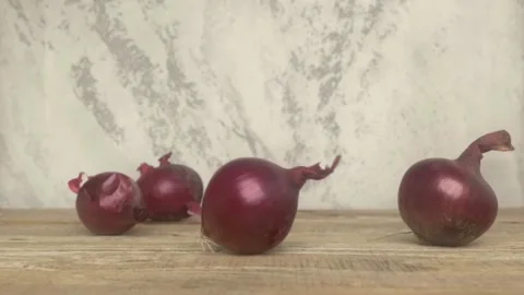 Fresh Red Onions Elegantly Positioned on a Rustic Wooden Table Background for Stockbeeldmateriaal 287117387
