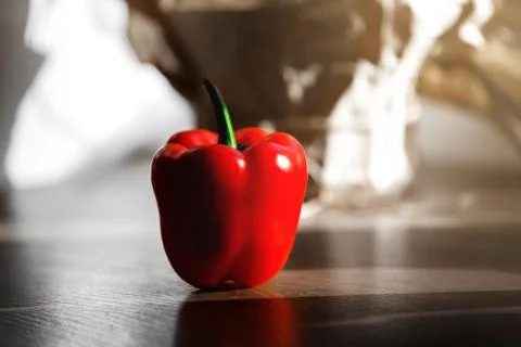 Fresh red pepper on a table with sun light from kitchen window Stock Photos