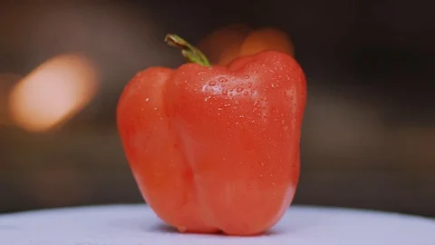 Fresh red peppers on white background scattering on table ingredient organic Video stock 100306845