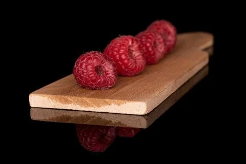 Fresh red raspberry isolated on black glass Stock Photos