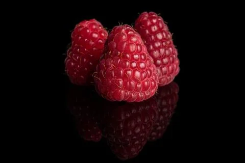 Fresh red raspberry isolated on black glass Foto stock
