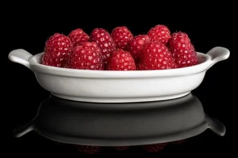 Fresh red raspberry isolated on black glass Stock Photos