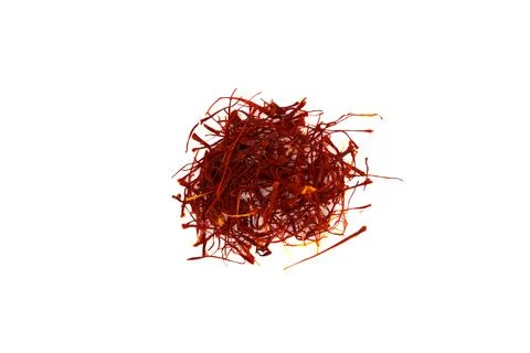 Fresh red saffron threads scattered on white background in minimalist Stock Photos